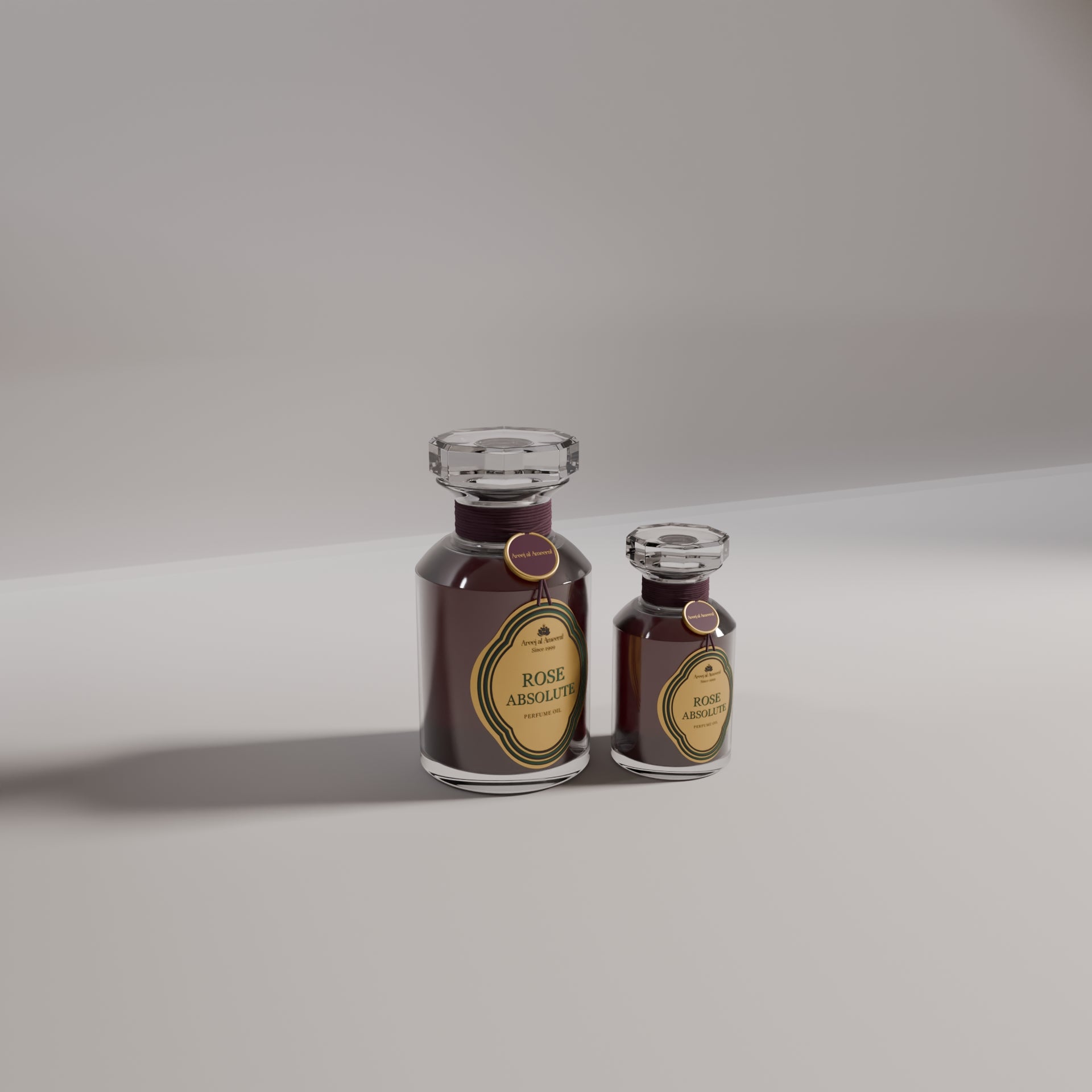 Two bottles of Areej Almeerat Rose Absolute perfume (big and small) with a dark, velvety liquid visible and a label that reads 'ROSE ABSOLUTE'.